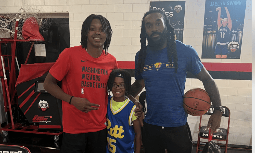 Bub Carrington, Aron Nwankwo, and Nwankwo's kid at a back-to-school event in Baltimore, Maryland.